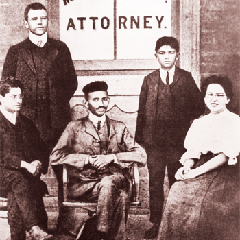 Gandhi with his secretary, Sonia Schlesin, and Mr. Polak in front of his office in Johannesburg,
