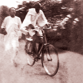 Gandhi riding bicycle
